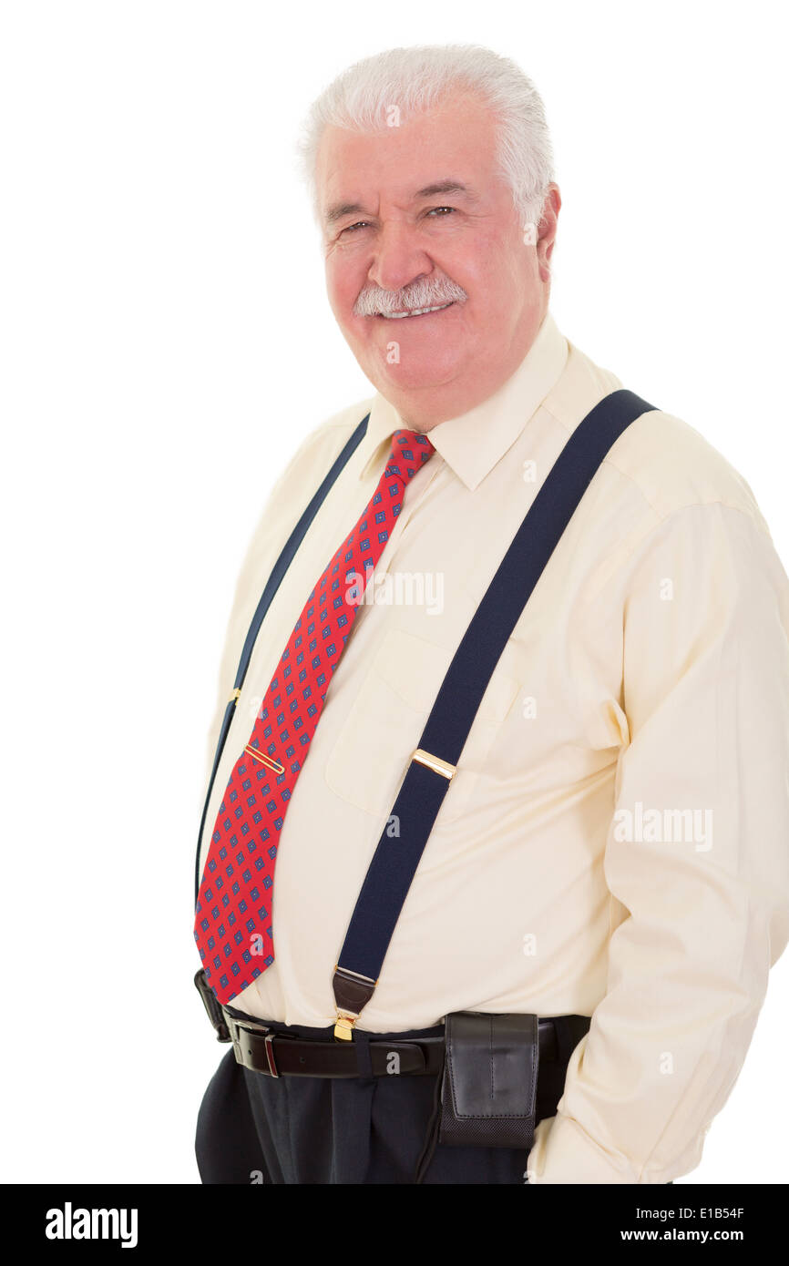 Confident relaxed senior man wearing braces standing smiling at the camera with his hands in his pocket Stock Photo