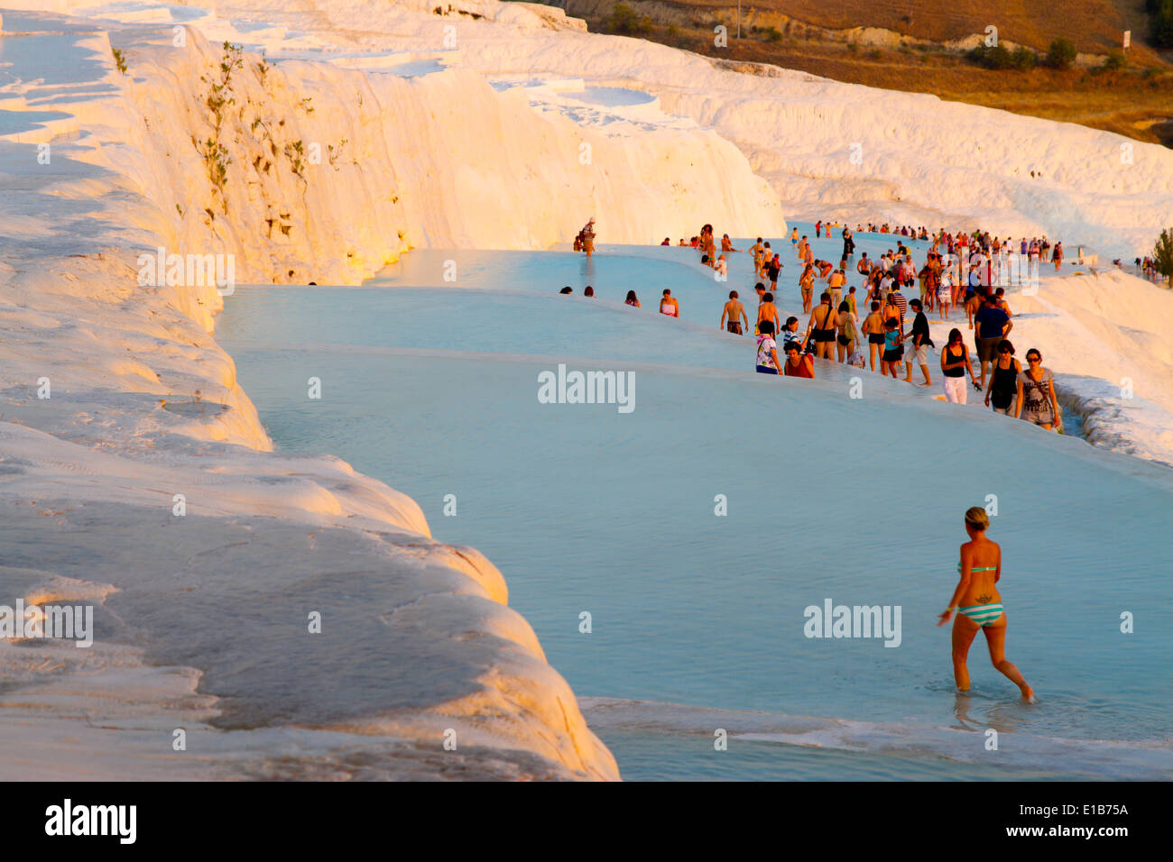 Travertine terrace formations and tourists. Pamukkale. Denizli province. Anatolia, Turkey. Stock Photo