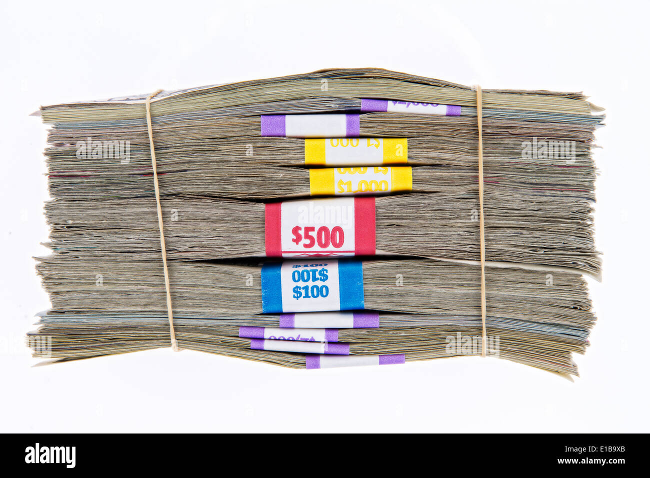 Bank bundles of different denomination dollar bills stacked on top of each other and secured with two rubber bands, side view Stock Photo