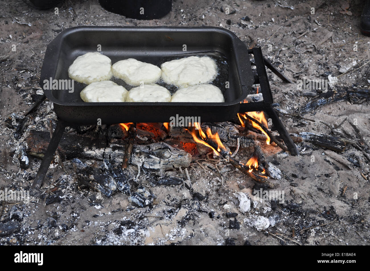 The national Park 'Ryazan Meshera', Russian Federation. Cooking pancakes on a fire in field conditions. Stock Photo