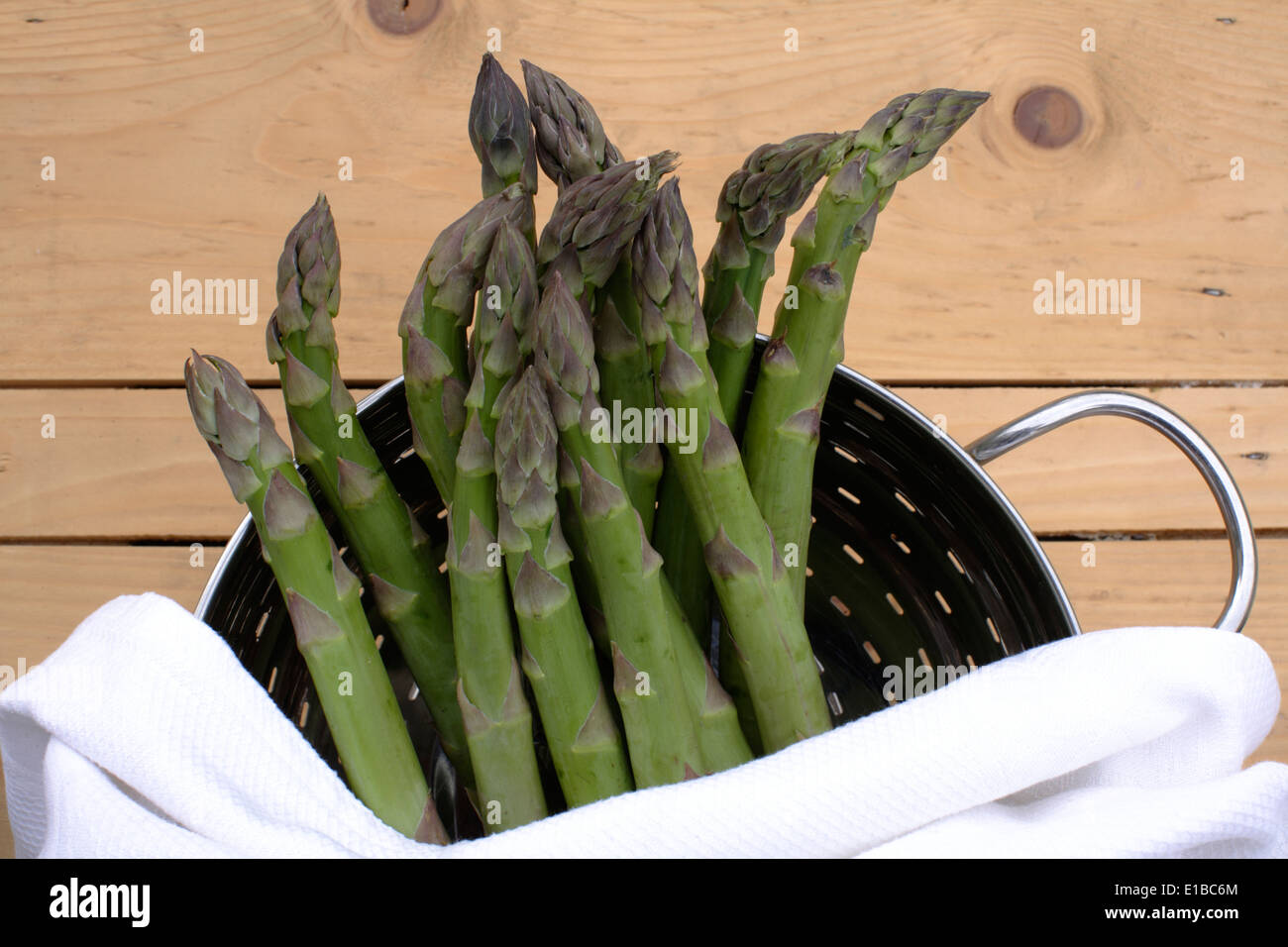 green asparagus lying in kitchenware Stock Photo