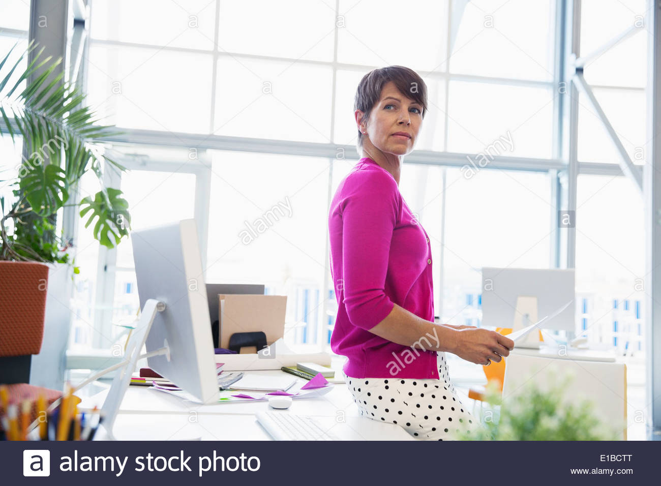 Businesswoman leaning over desk hi-res stock photography and images - Alamy