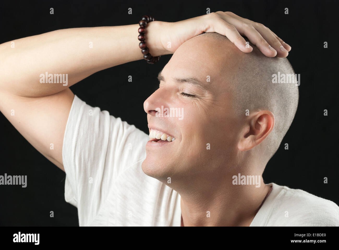 Close-up of a man feeling his newly shaved head. Stock Photo