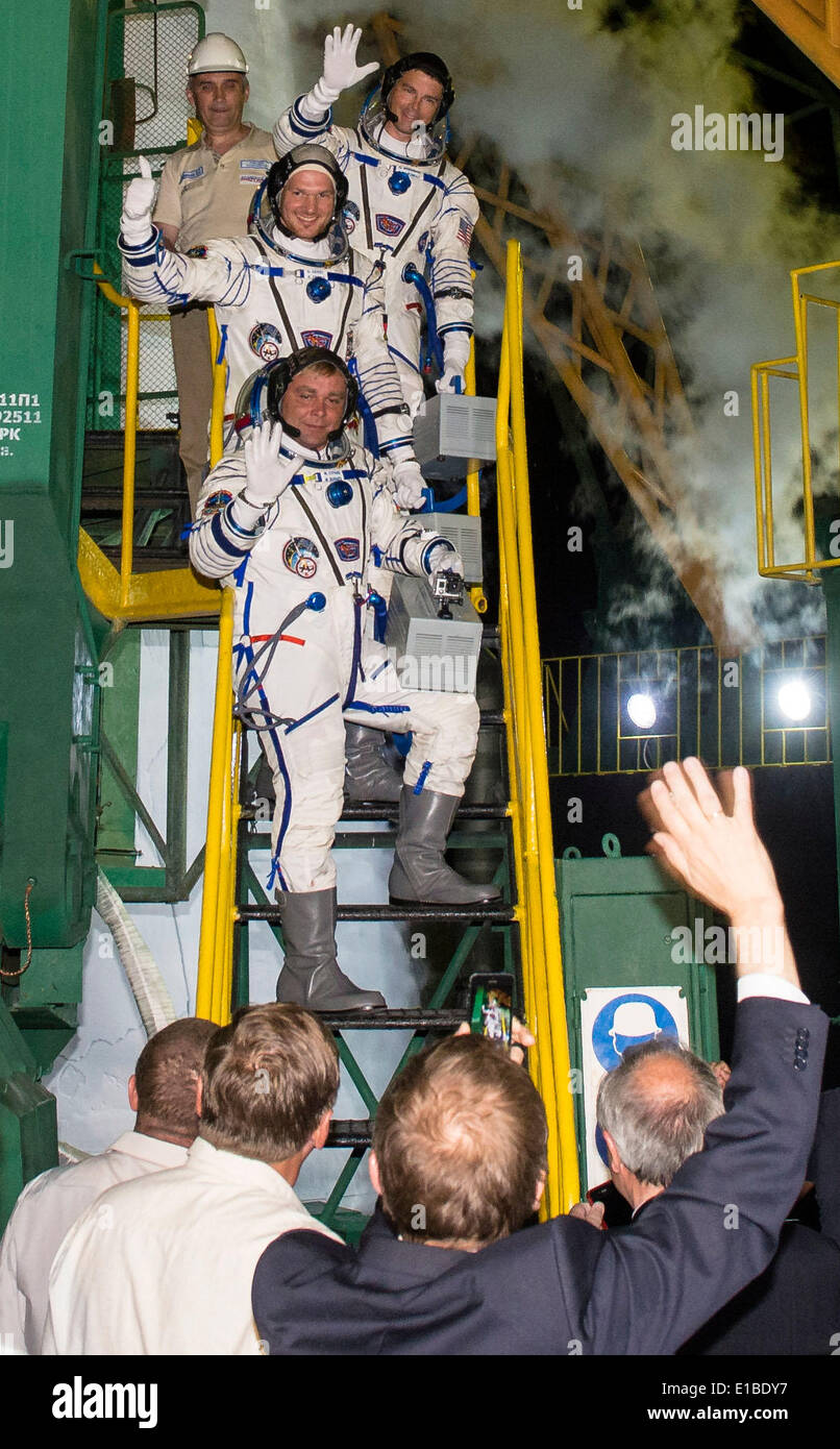 International Space Station Expedition 40 Soyuz Commander Maxim Suraev of the Russian Federal Space Agency, Roscosmos, bottom, Flight Engineer Reid Wiseman of NASA, center, and Flight Engineer Alexander Gerst of the European Space Agency, ESA, top, wave farewell prior to boarding the Soyuz TMA-13M rocket for launch May 28, 2014 at the Baikonur Cosmodrome in Kazakhstan. Suraev, Gerst, and Wiseman will spend the next six months aboard the International Space Station. Stock Photo
