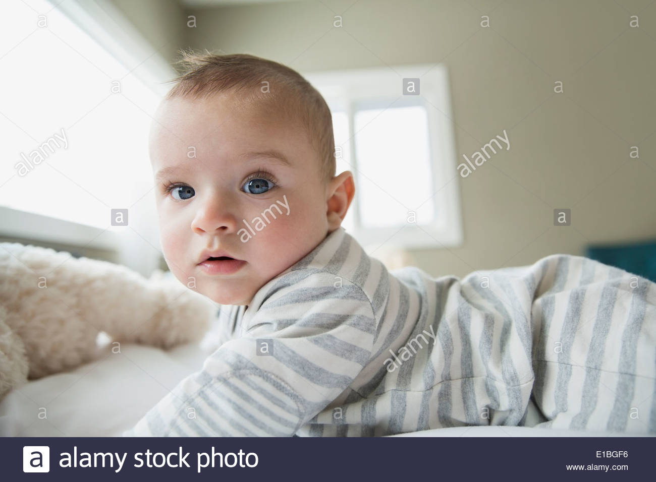 Portrait of serious baby on bed Stock Photo