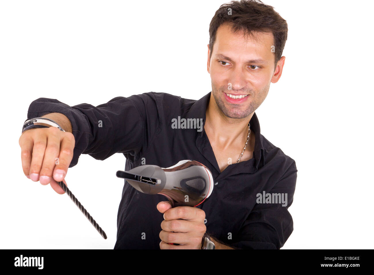 young stylist with blow dryer and comb for hair Stock Photo