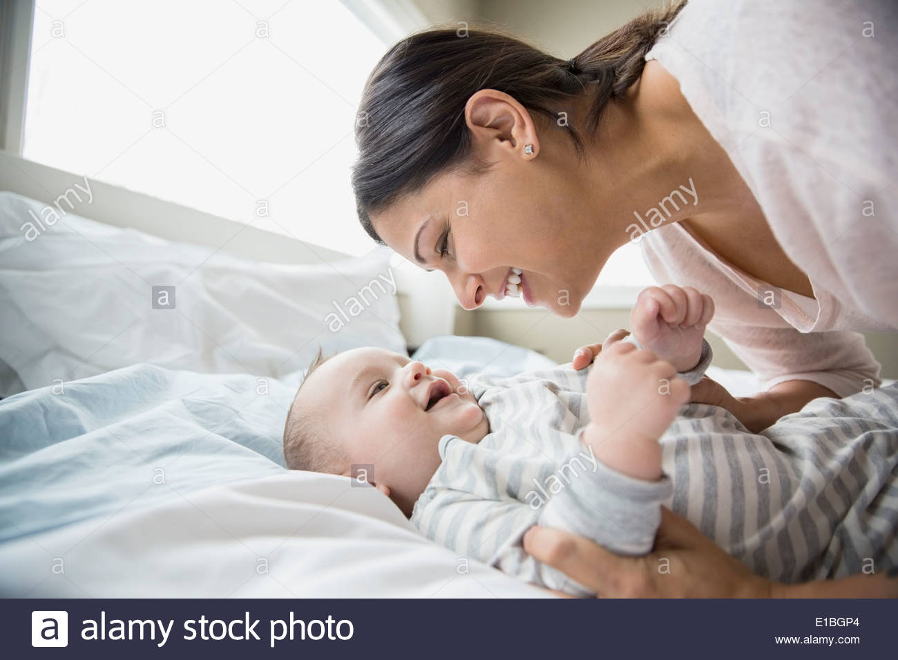 Mother and baby on bed Stock Photo