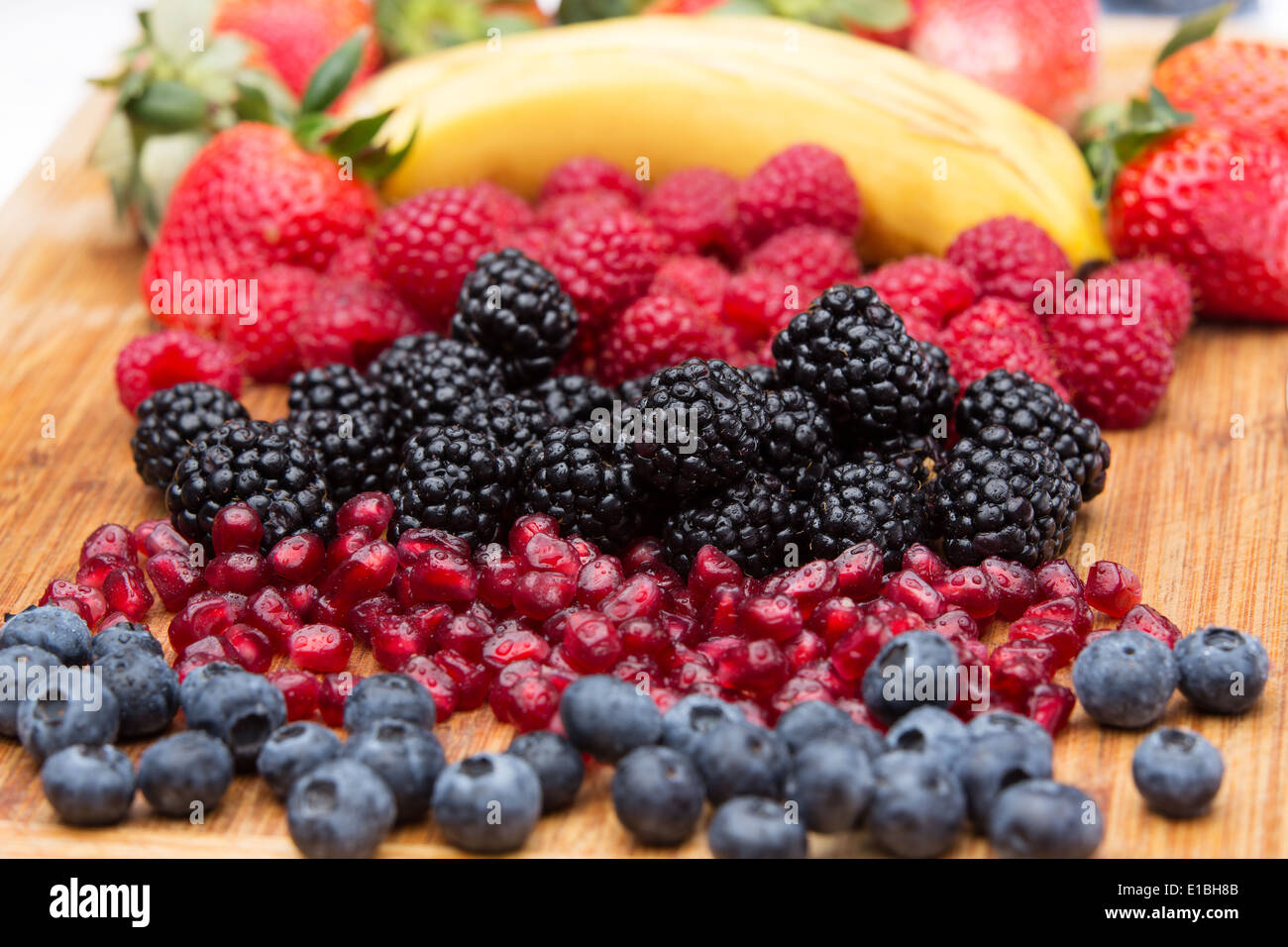 Fresh Washed Assorted freshly washed fruit in the kitchen arranged on a wooden ...