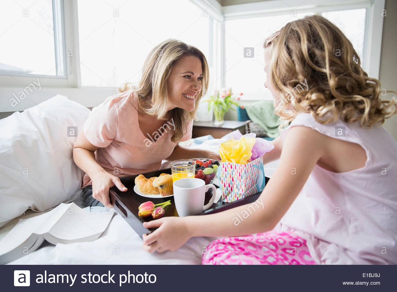 Daughter bringing breakfast to mother in bed Stock Photo Alamy