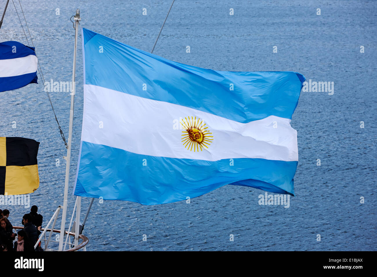 large argentinian flag flying off the back of a boat in Ushuaia Argentina Stock Photo