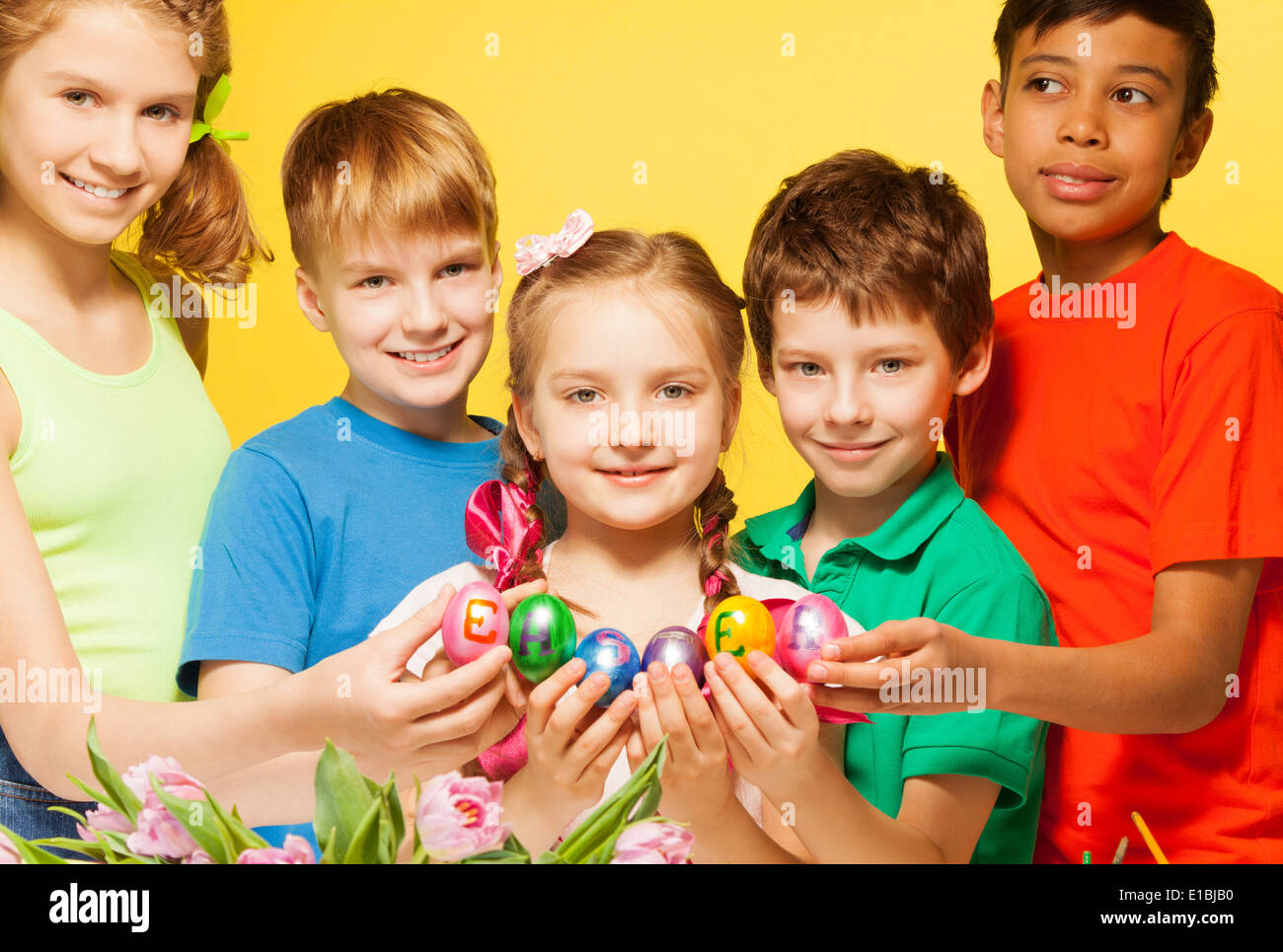 Five kids portrait who hold Eastern eggs Stock Photo