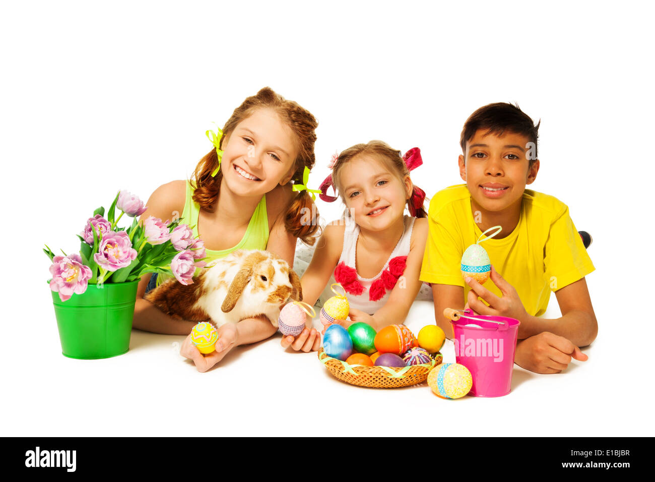 Three cheerful kids together with Eastern eggs Stock Photo
