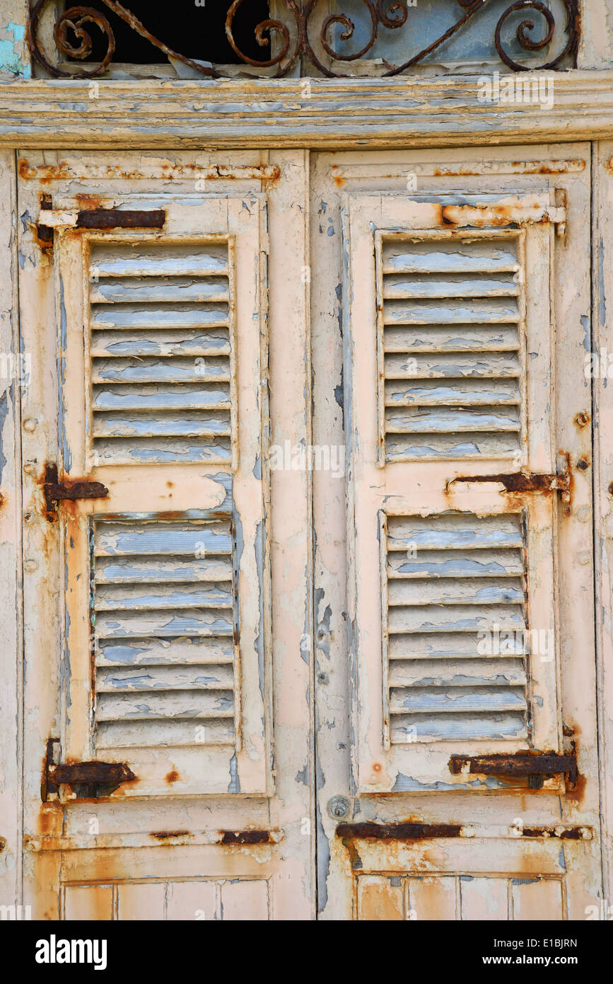 Faded shutters on dilapidated building, Saint Paul's Bay (San Pawl il-Baħar), Northern District, Republic of Malta Stock Photo