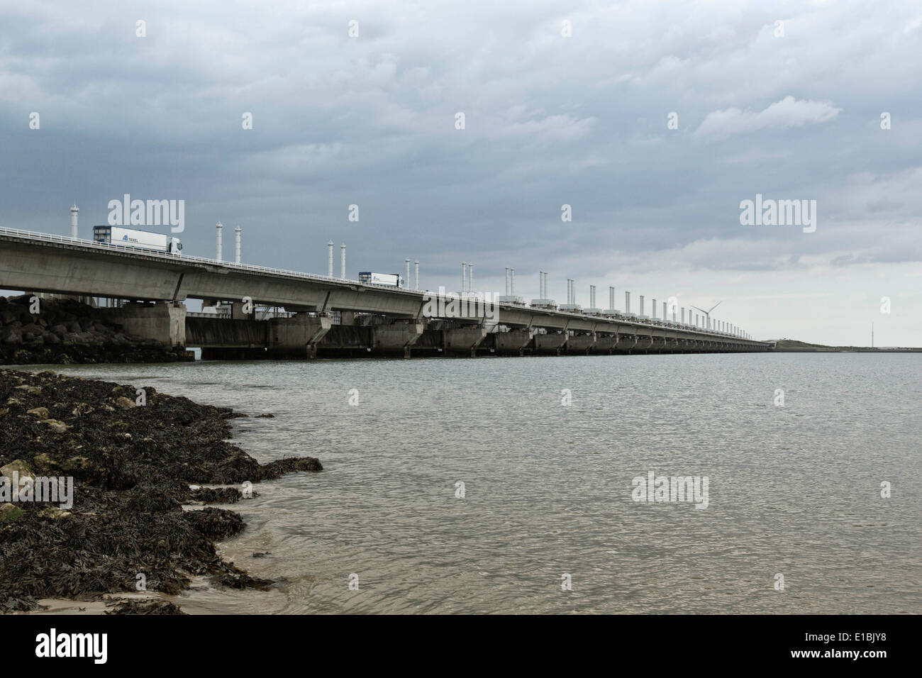 May 20, 2014 - Zeeland, The Netherlands - The Delta works are the best and largest storm barriers in the world. There is a reason why the dams are nicknamed 'the eighth wonder of the world'. They were designed after the floods of 1953 and offer protection to the land surrounding the Rhine-Meuse-Scheldt delta. With the Delta Works, the chances of another flood have been reduced to once every 4000 years.The works consist of dams, sluices, locks, dykes, levees, and storm surge barriers. The aim of the dams, sluices, and storm surge barriers was to shorten the Dutch coastline, thus reducing the nu Stock Photo