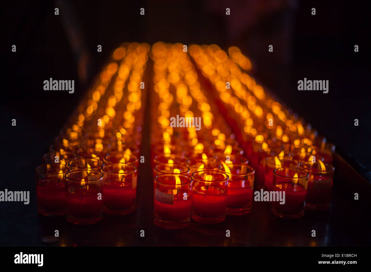 Church candles in red transparent chandeliers Stock Photo Alamy