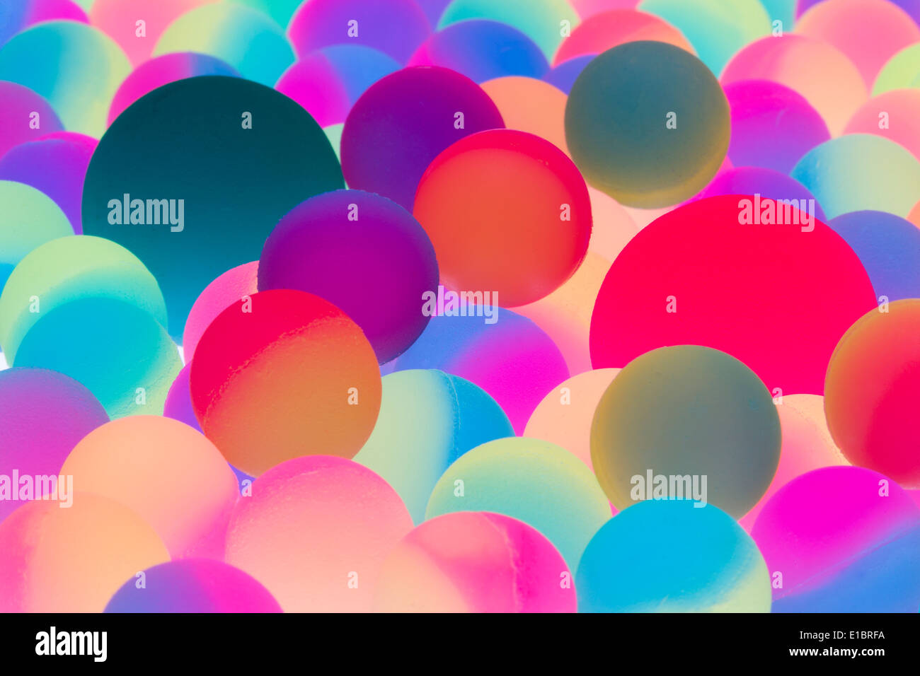 Illuminated bicolor balls background in the colors of the spectrum with a close up view of multiple balls of different sizes in Stock Photo