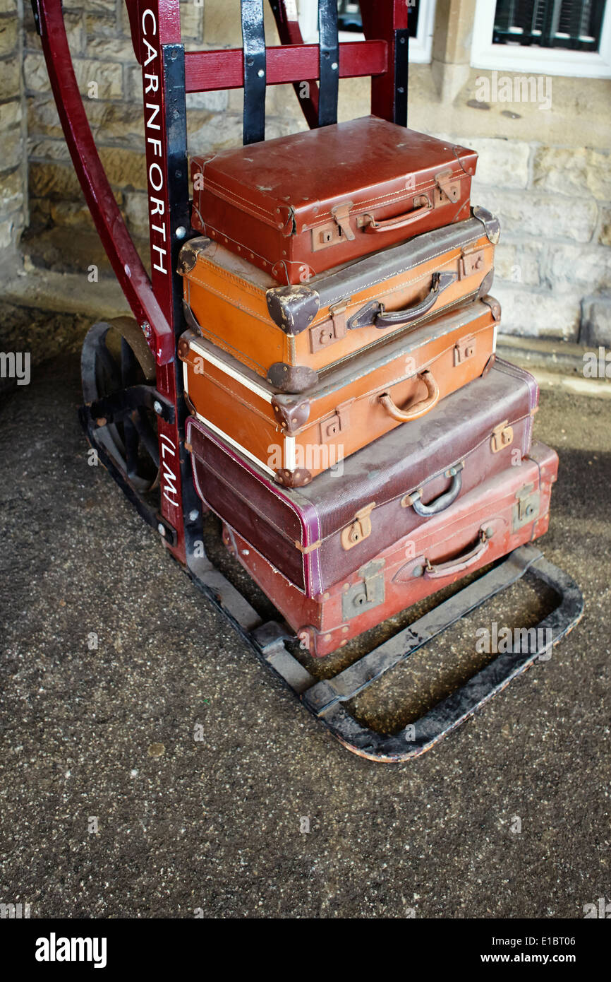 Stack of old suitcases at railway station Stock Photo