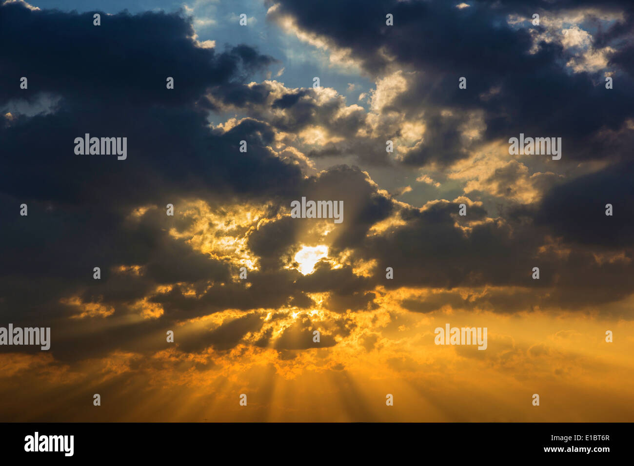 Sunbeam ray light through cloud sky twilight color blue and orange Dramatic background Stock Photo