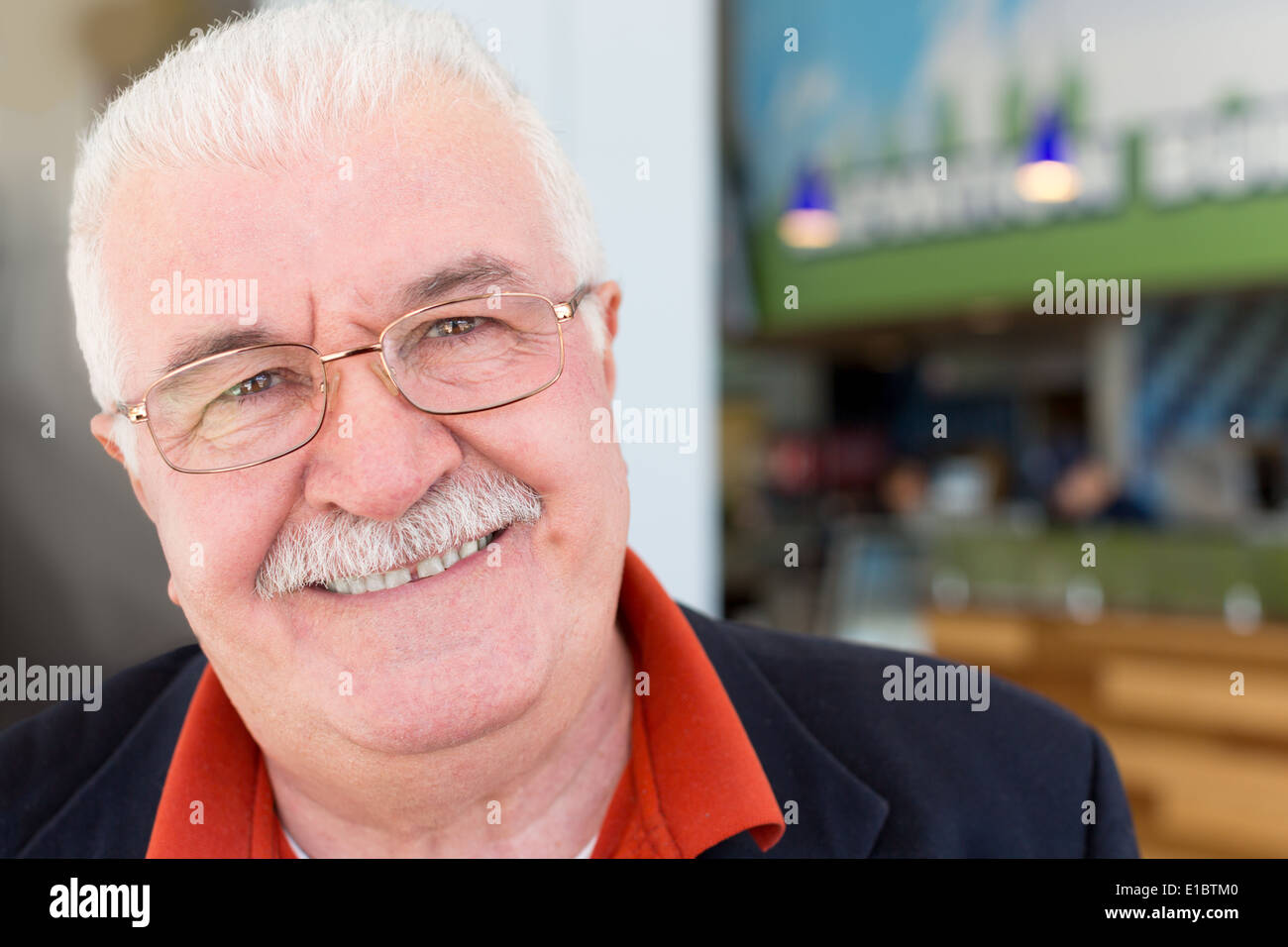 Close up portrait of the face of an attractive friendly sincere senior grey-haired man in glasses with a mustache looking Stock Photo