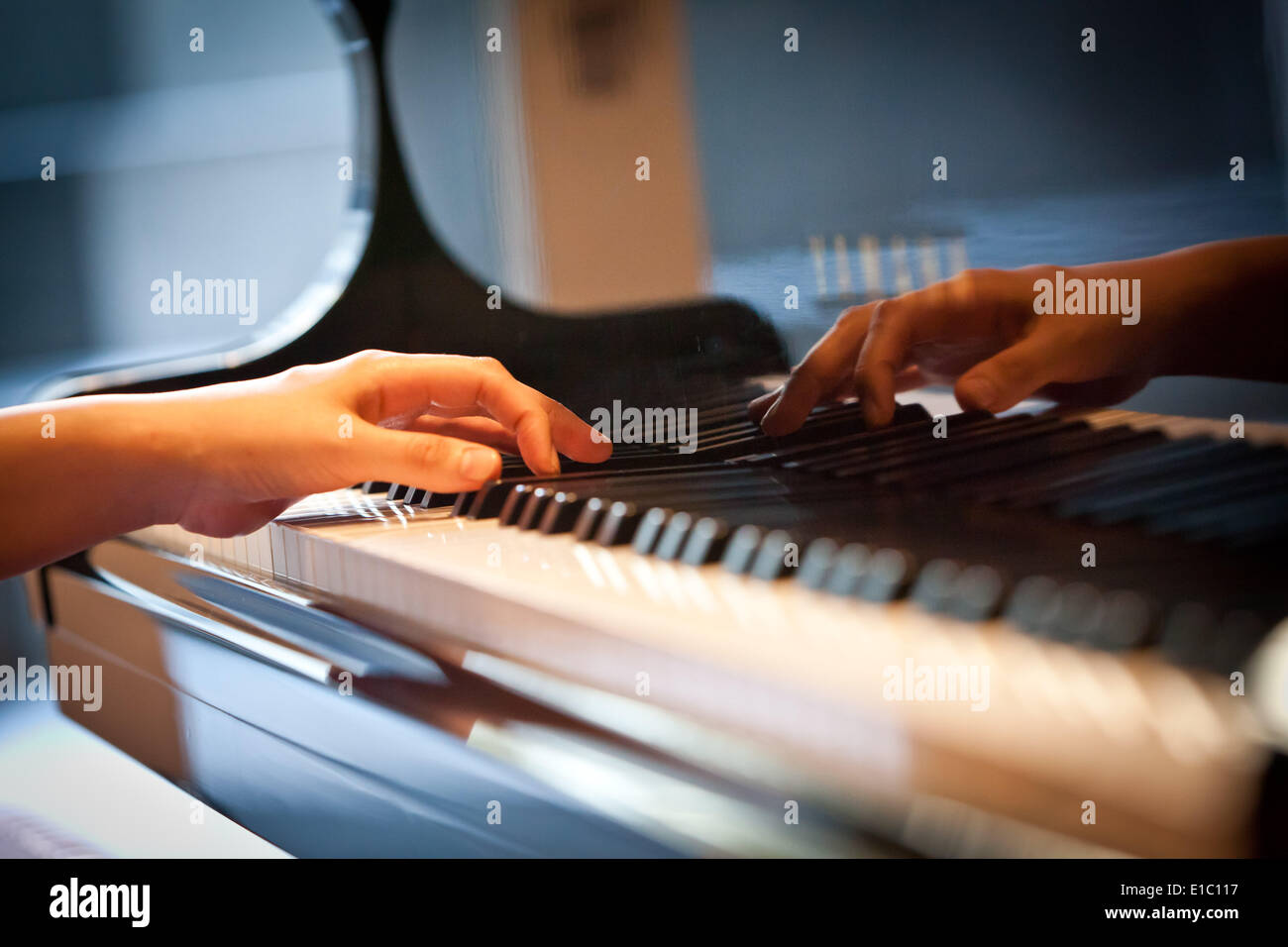 Hand on the keyboard of a piano, playing classical music, in May 2013