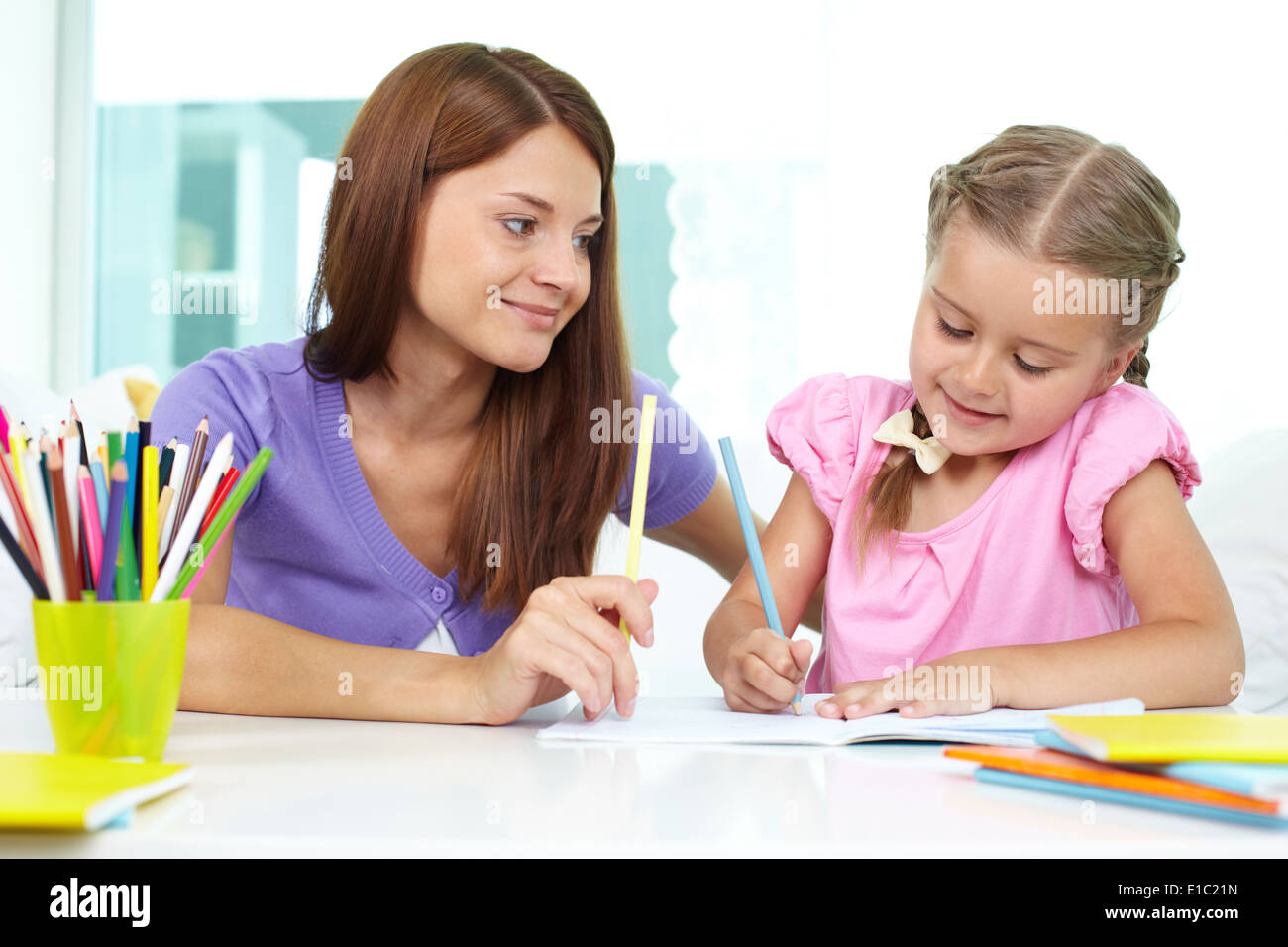 Mother and daughter spending time together at home drawing Stock Photo ...