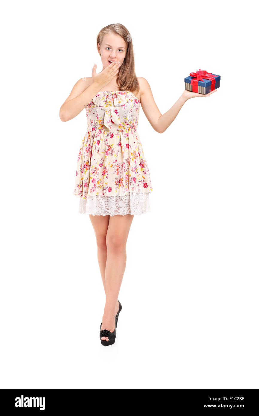Full length portrait of a surprised young girl holding a present Stock ...