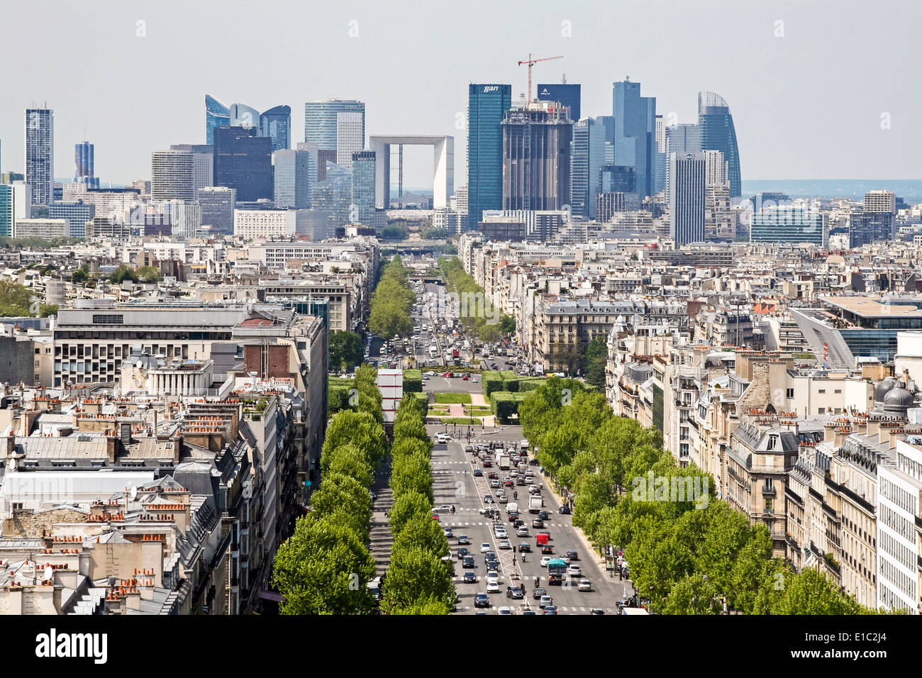 Looking down Paris road towards La Grand Arche and modern office buildings at La Defense, view from Arc de Triomphe Stock Photo