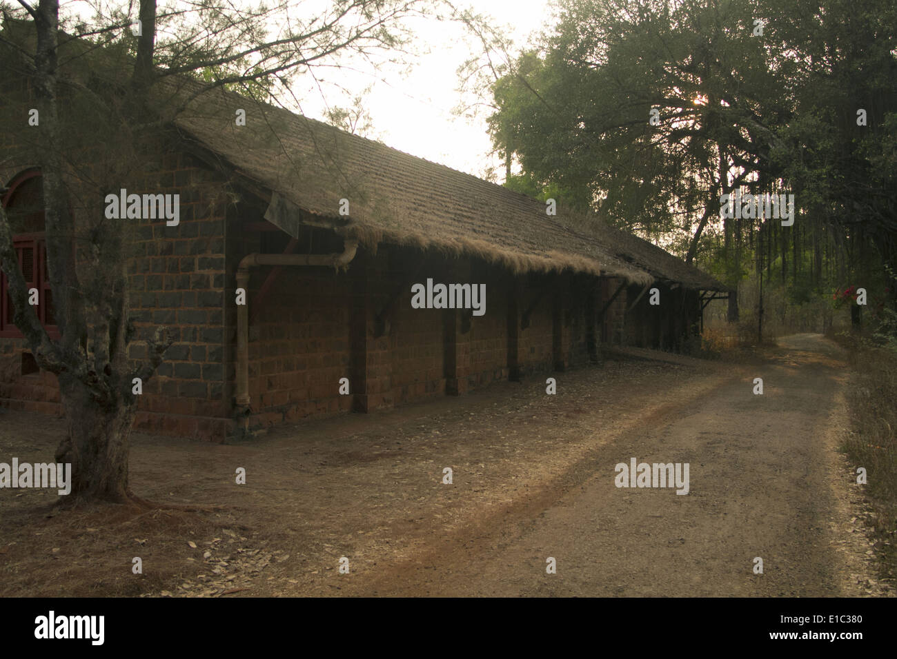 Old house by a dirt road in a village , Belgaum, Karnataka, India Stock Photo