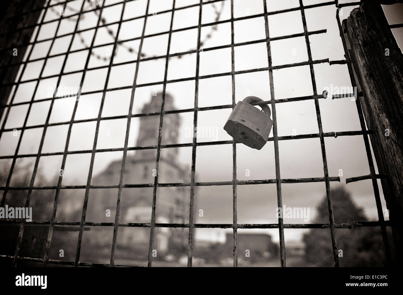 Locked gates in front of ruin of old mill at Bamber Bridge,preston,Lancashire,UK Stock Photo