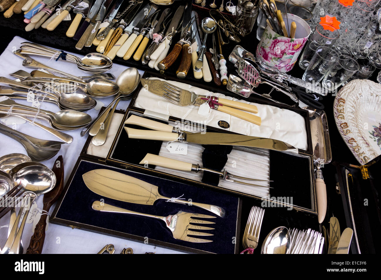Various old kitchen utensils on display at outdoor market in Stroud