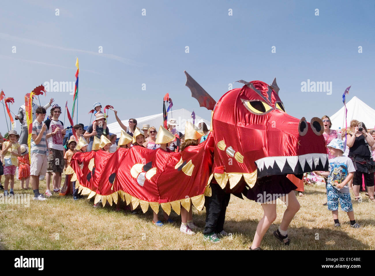 Tewkesbury Medieval Festival, Gloucester UK July 2013: alchemy entertain children with giant puppet dragon at the dragon parade Stock Photo