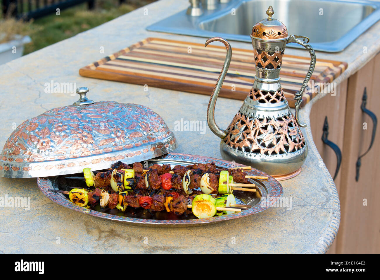 https://c8.alamy.com/comp/E1C4E2/grilled-beef-kebabs-with-tomato-onion-and-zucchini-served-on-a-metal-E1C4E2.jpg