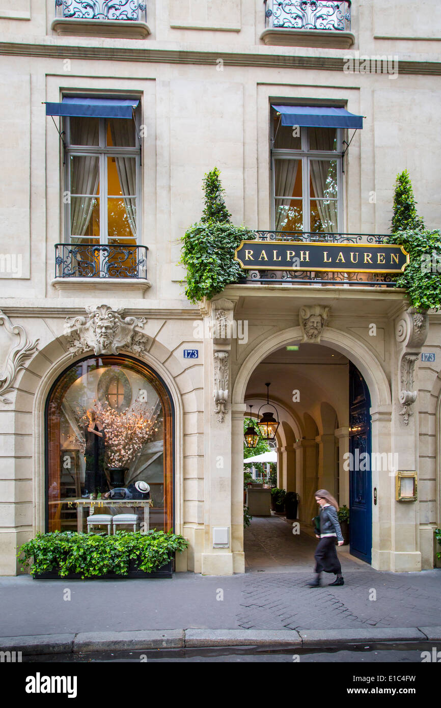 Woman walks past entry to Ralph Lauren store and restaurant in Saint-Germain-des-Pres, Paris France Stock Photo