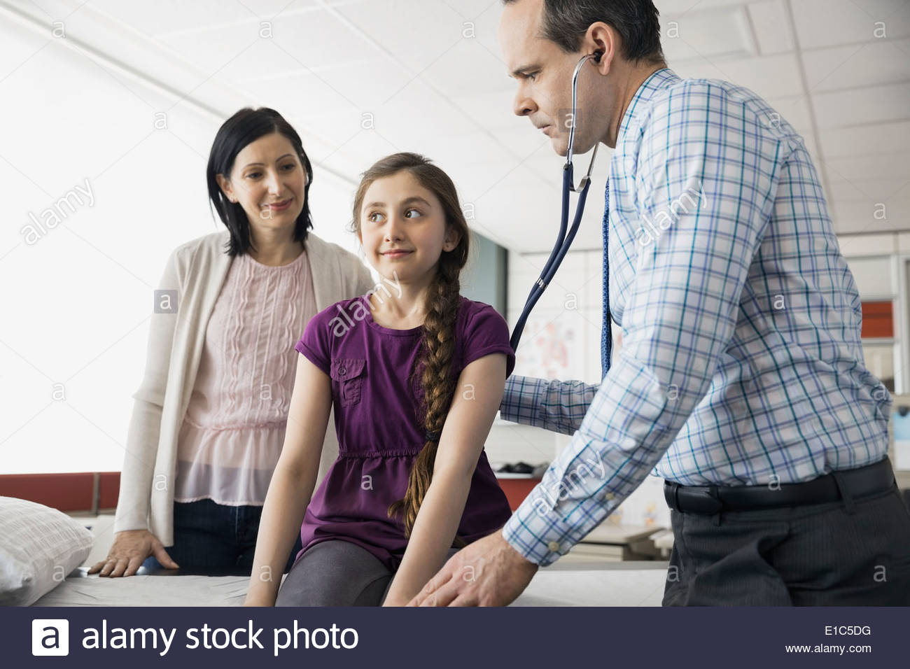 Pediatrician checking patientÕs breathing with stethoscope Stock Photo