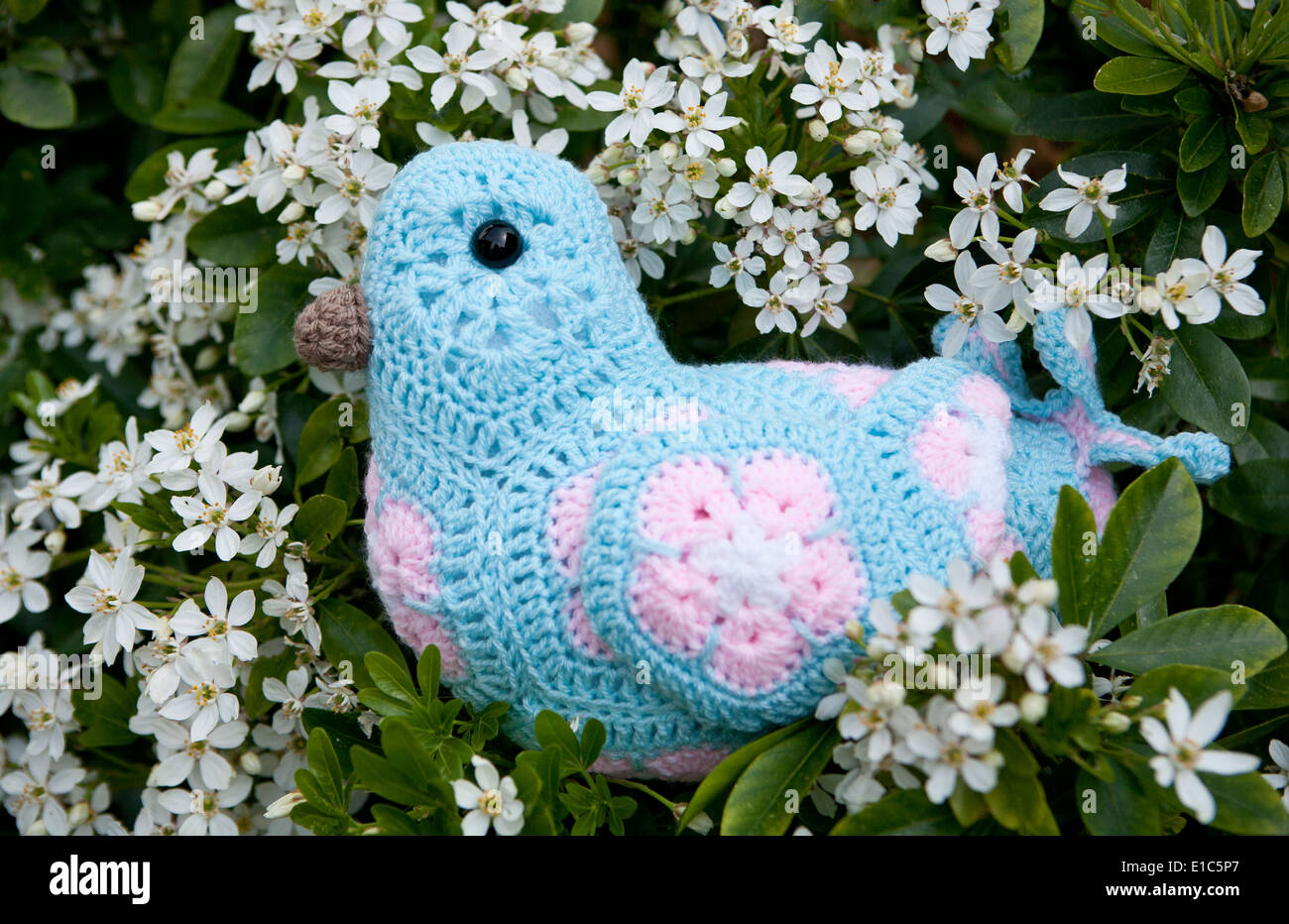Handmade crocheted toy bird using African Flower Pentagons motifs Stock Photo