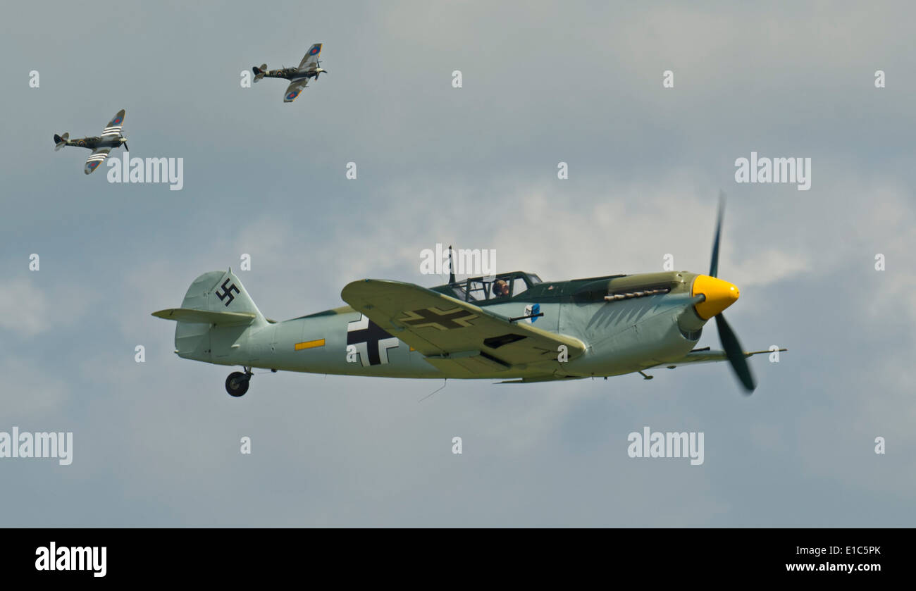 DUXFORD, ENGLAND. A blended image of Two Supermarine Spitfires with the D-Day livery and a Messerschmitt Bf 109 in action Stock Photo