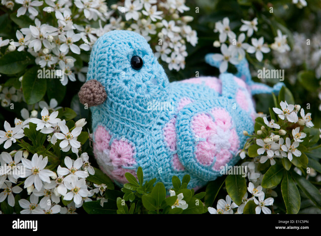 Handmade crocheted toy bird using African Flower Pentagons motifs Stock Photo