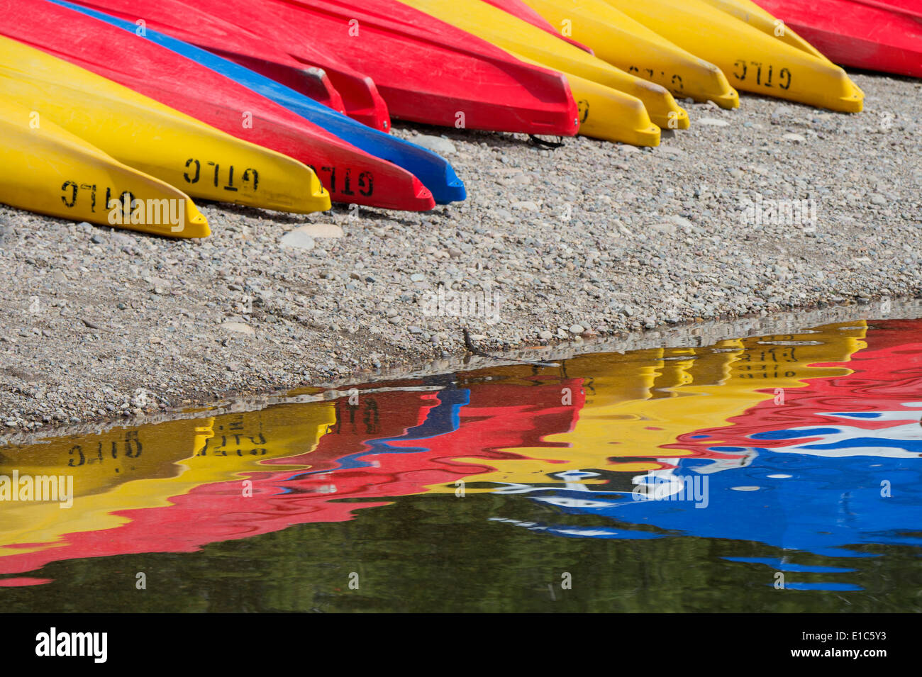Kayaks for hire, laid out on the shores of Colter Bay at Jackson lake in the Grand Teton National Park. Stock Photo
