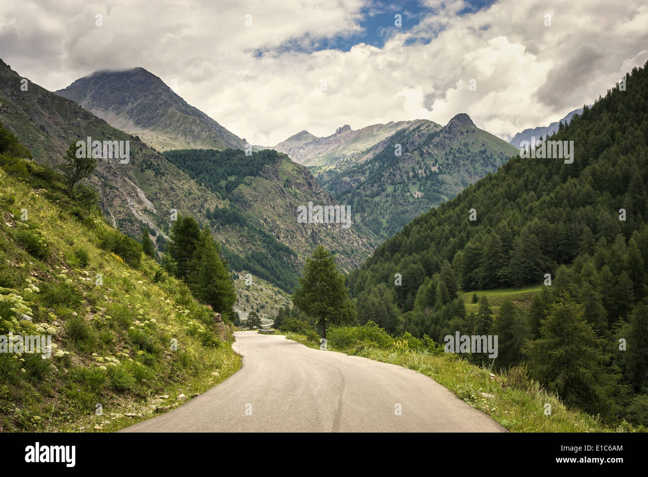 Mountains with scenic mountain road in the Mercantour National Park, France - empty mountain road Stock Photo