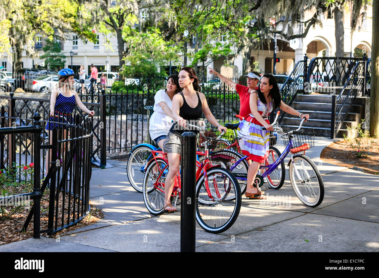 Teenage girls riding hired bicycles as they tour around Savannah GA Stock Photo