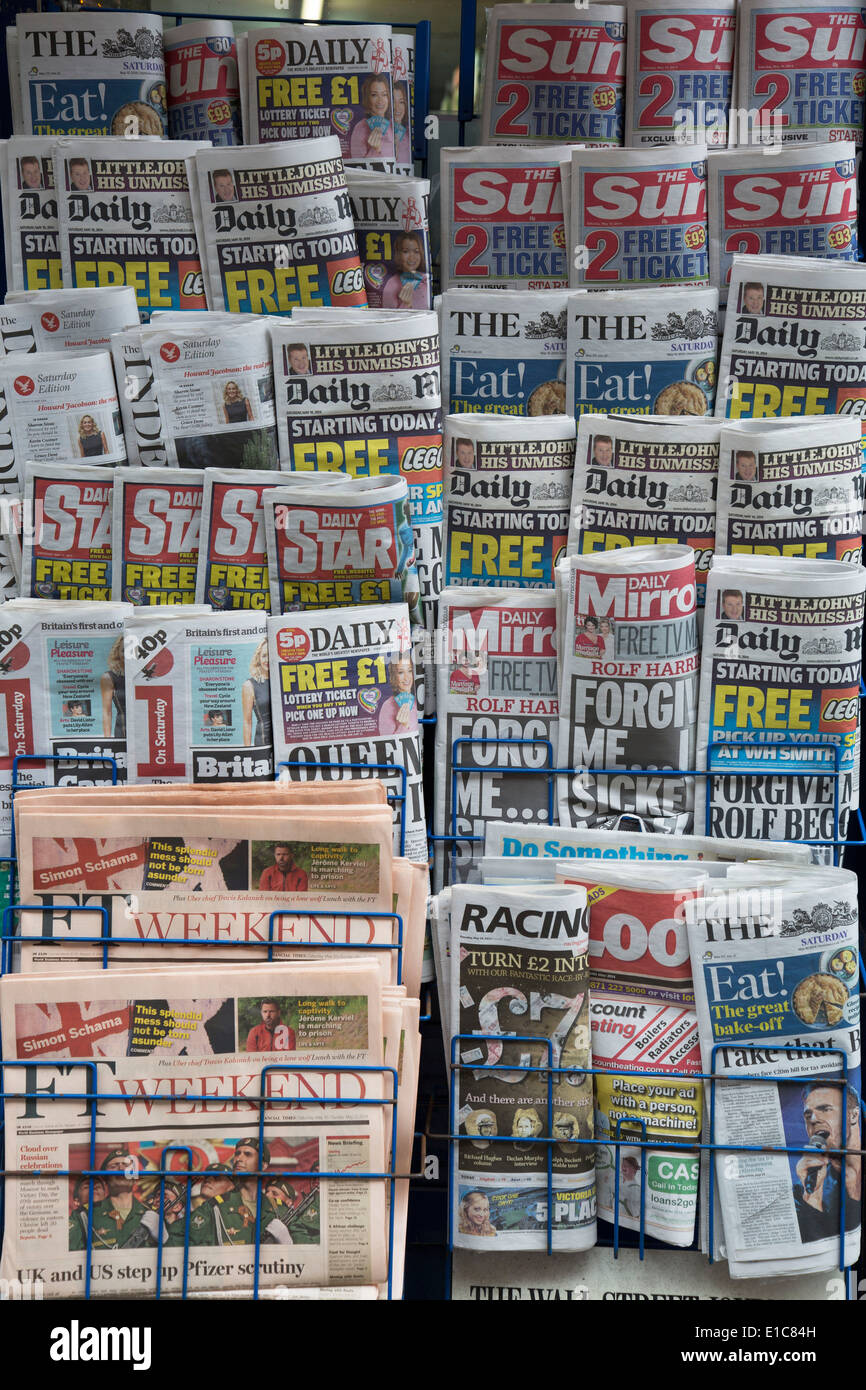 Stand of tabloid newspapers at a newsagents. London, UK. The Sun, the Daily Mail, The Star, Daily Mirror predominantly. Stock Photo