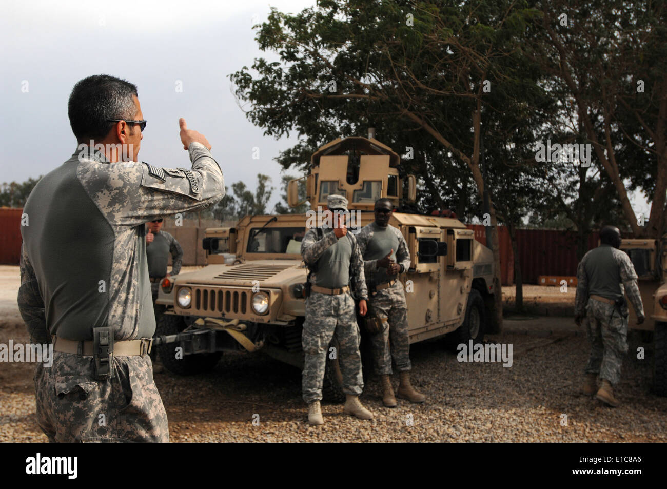 U.S. Army Sgt. Maj. Rafael Caraballo, left, assigned to the 6th Iraqi Army Division, Military Transition Team, receives verific Stock Photo