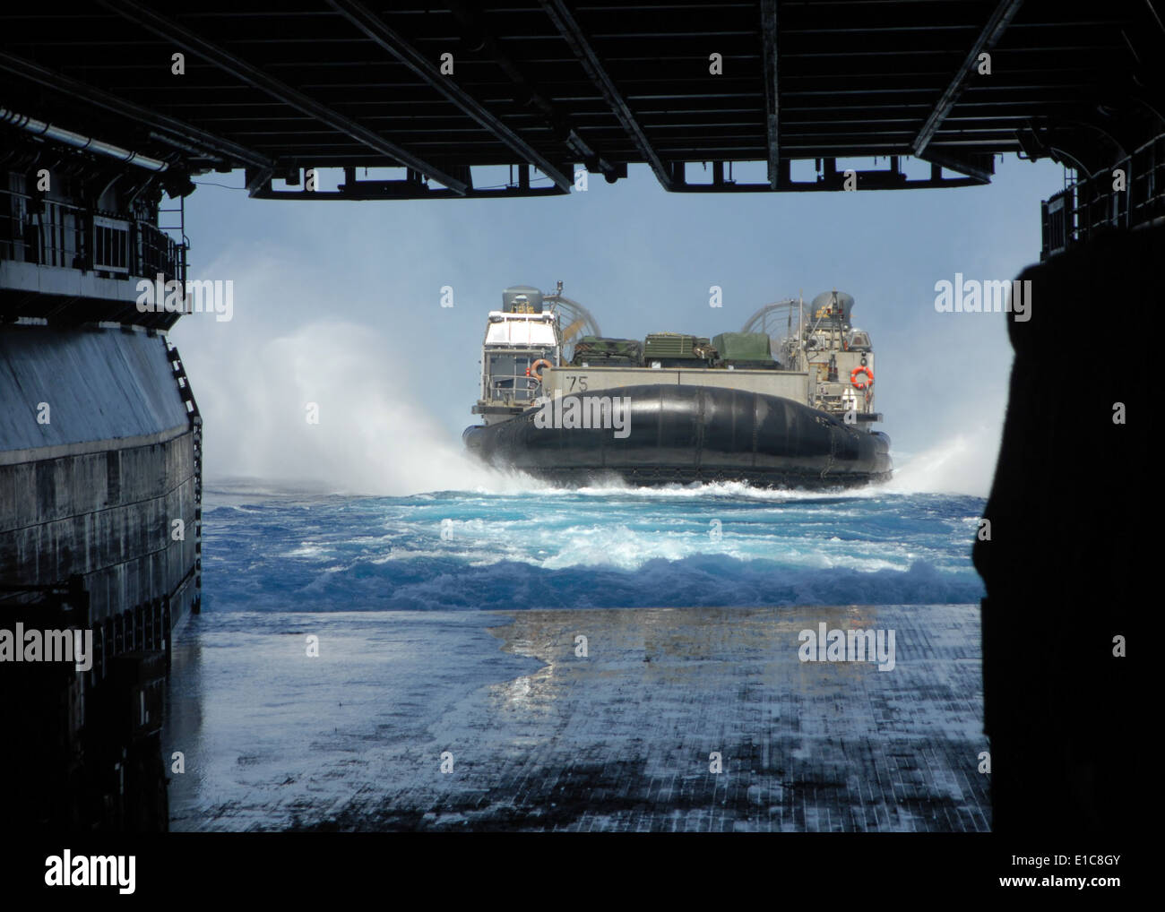 A landing craft, air cushion prepares to enter the well deck of the amphibious assault ship USS Bonhomme Richard (LHD 6) while Stock Photo