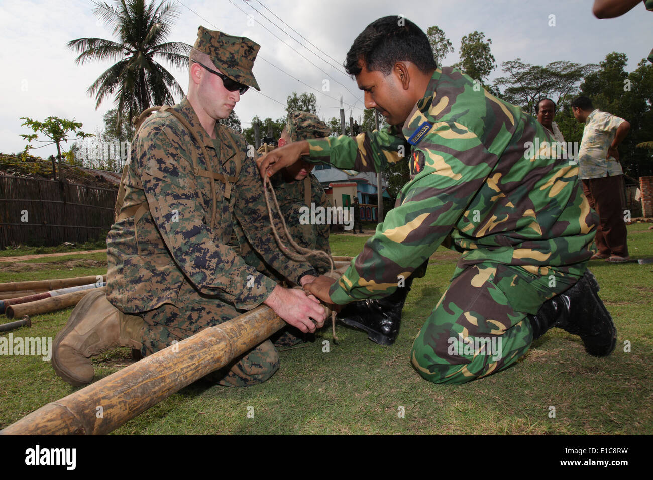 Bangladesh Armed Forces Division Lance Cpl. Nowab with 18th Engineer battalion, prepares to tie toggether a bamboo ladder with Stock Photo