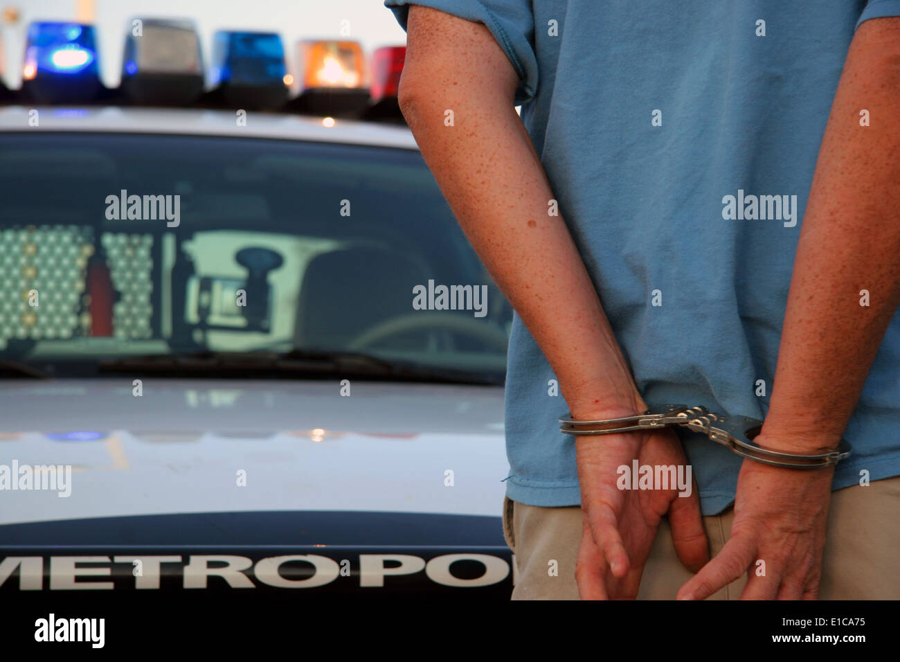 Man in handcuffs standing in front of a police car in Las Vegas, Nevada
