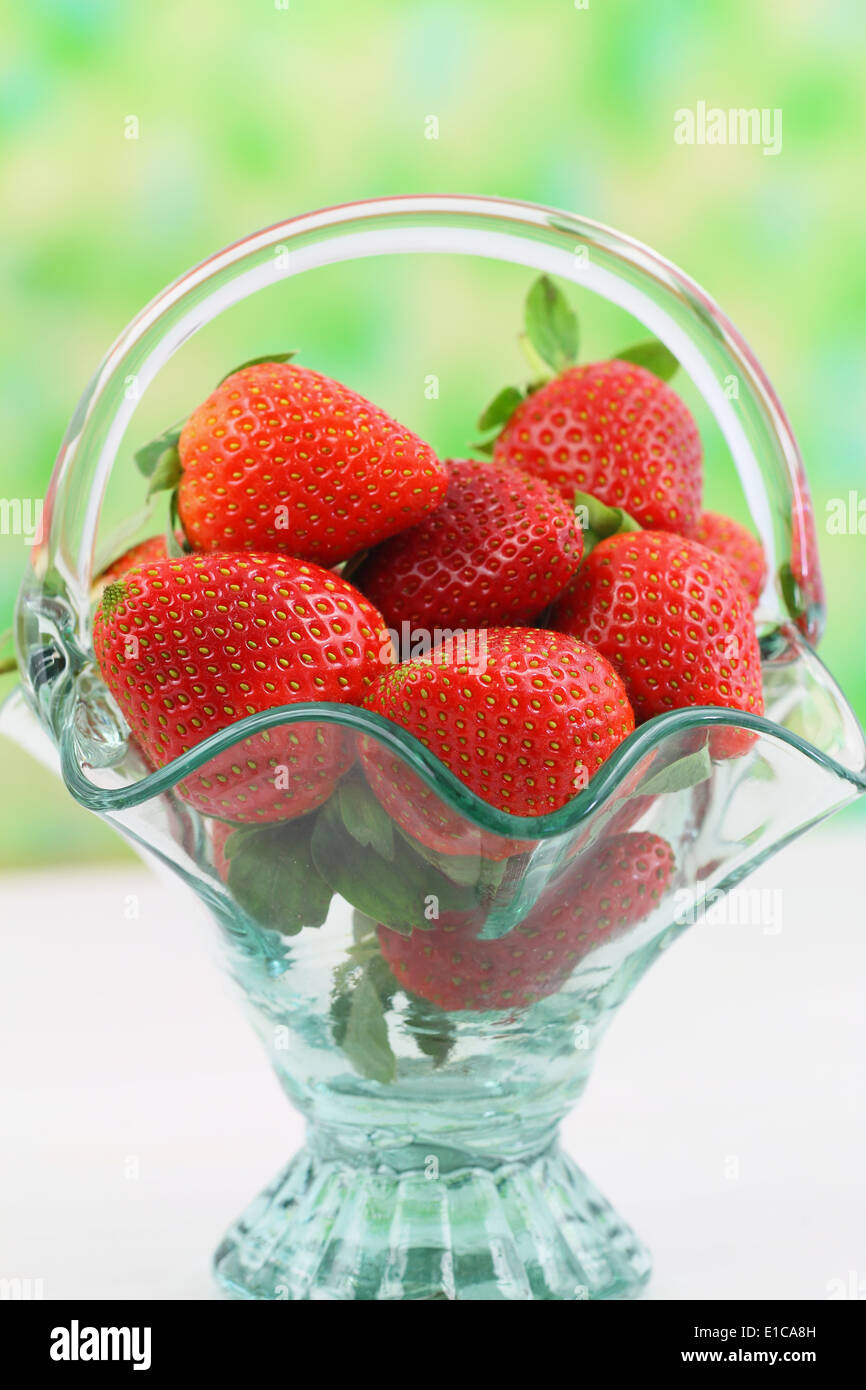Fresh strawberries in vintage glass basket with copy space Stock Photo