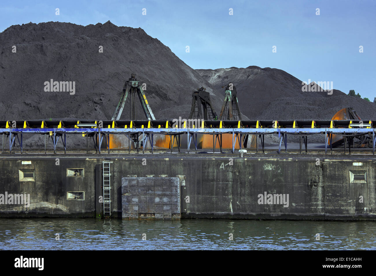 Heaps of coal at SEA-invest / Ghent Coal Terminal at the port of Ghent, East Flanders, Belgium Stock Photo