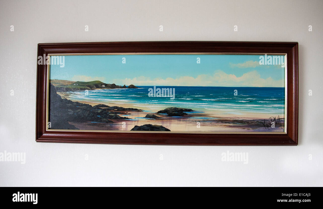 A photograph of an oil painting hanging in a wall with a coastal view Stock Photo