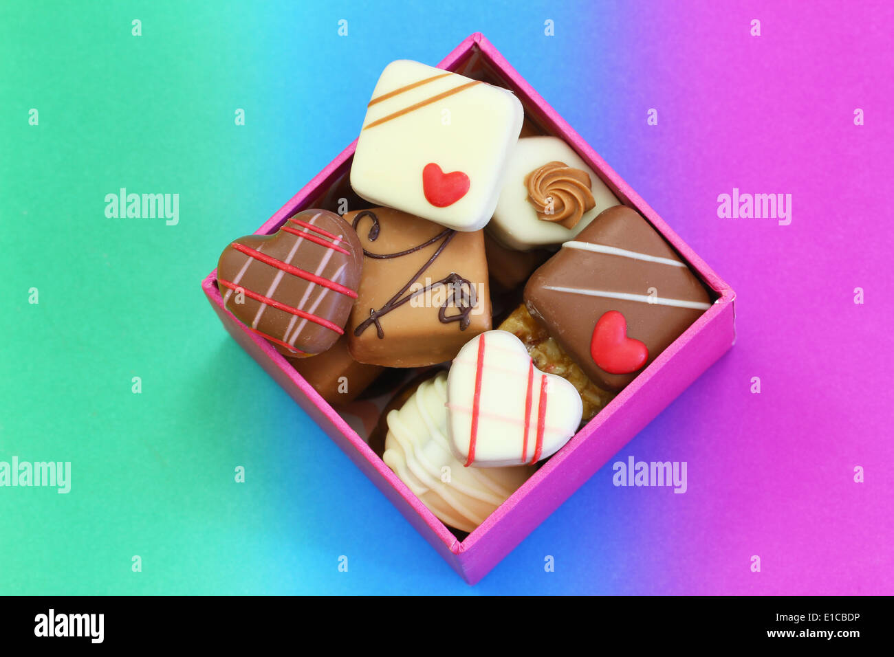 Assorted chocolates in box on colorful background Stock Photo