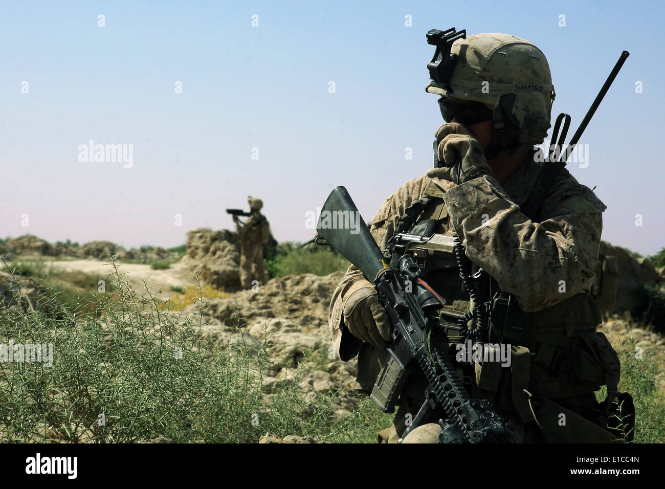 U.S. Marine Corps Lance Cpl. Scott Nechay uses a radio during a security patrol in the Helmand province of Afghanistan July 27, Stock Photo